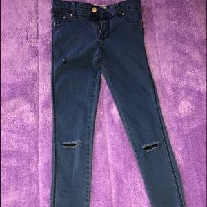 Dark blue distressed denim jeans